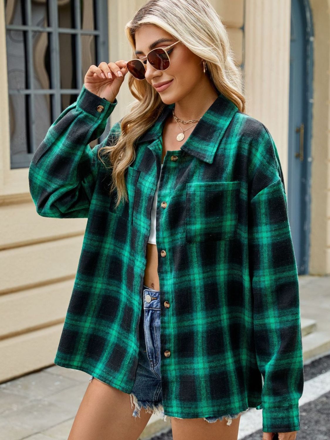 Dark Green and Black plaid collared long sleeve button-up shirt with chest pockets.