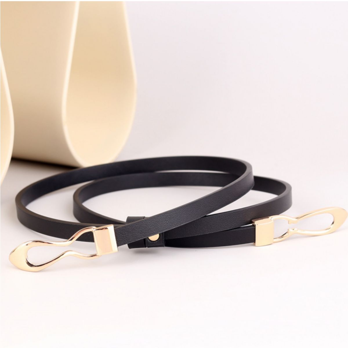 Black leather belt with gold interlocking buckle detail