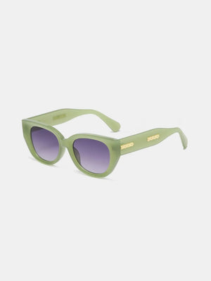 Sage green sculpted cat eye sunglasses with gold accents and gradient lenses.