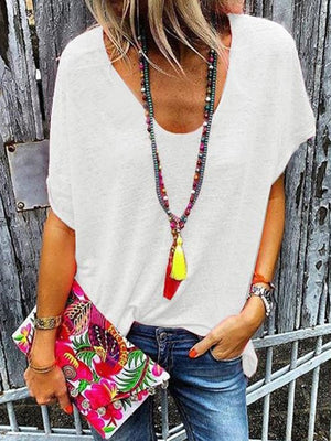 White relaxed v-neck tee with dolman sleeves and a casual fit.