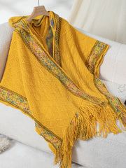 Mustard yellow knit hooded wrap with diamond pattern and colorful embroidered trim.