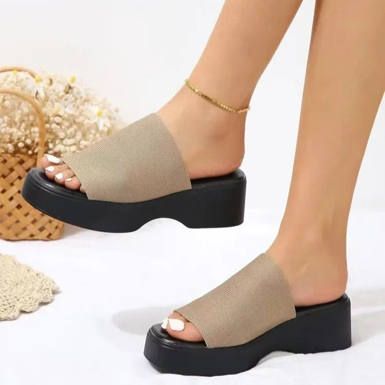 Platform knit slide sandals in khaki with black platform sole.