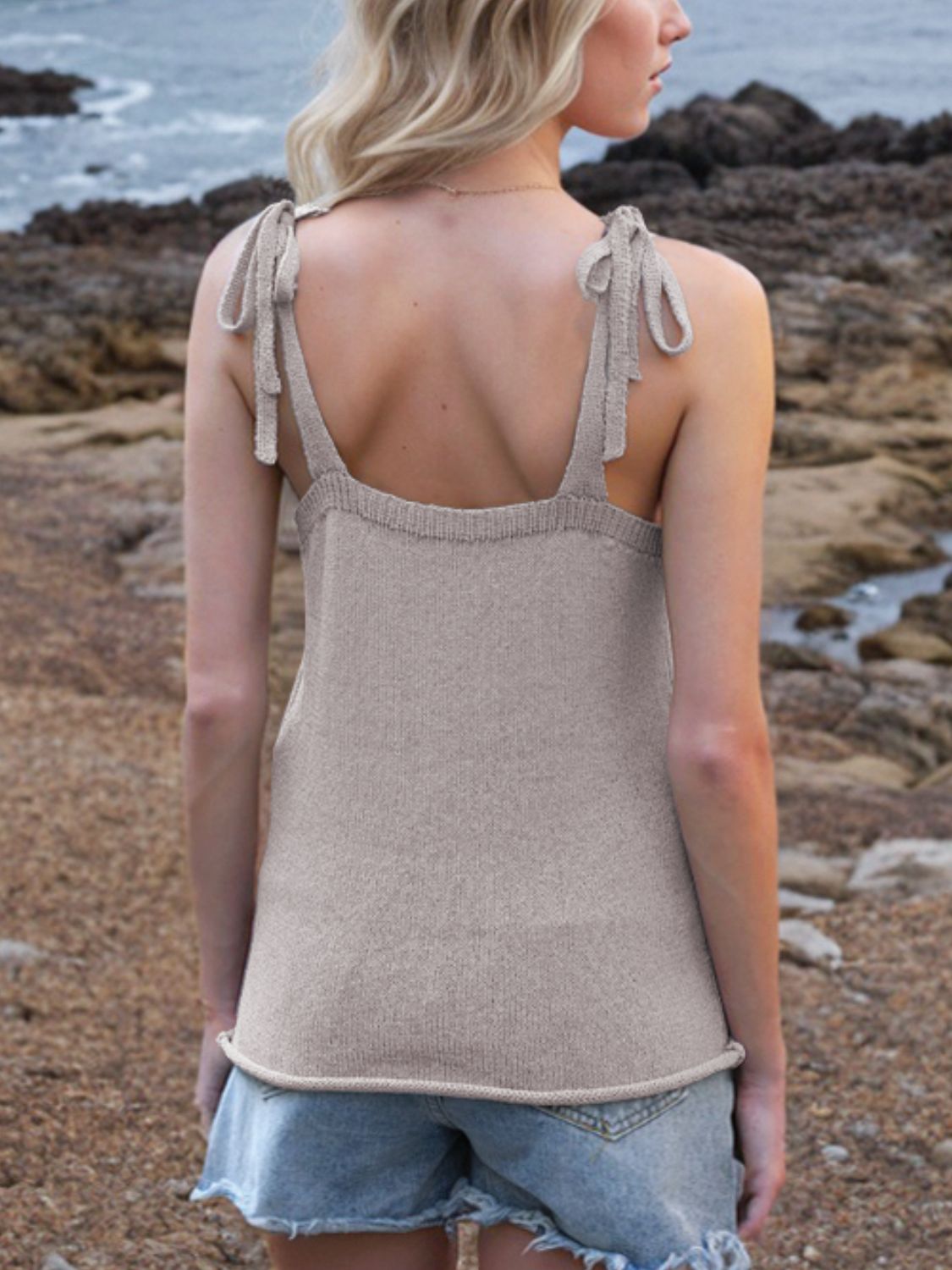 Knit tank top in Mocha with tie straps and deep V-neck, styled with denim shorts.