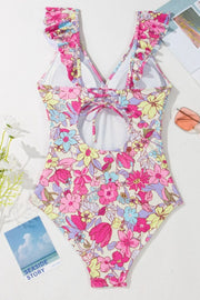 Floral ruffle backless swimsuit with lace-up back and cutout detail in fuchsia pink.