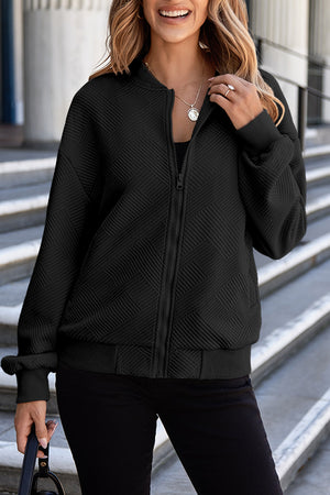 Black bomber jacket with diamond quilting and zip front.