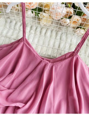 Pink camisole with spaghetti straps and delicate ruffles.