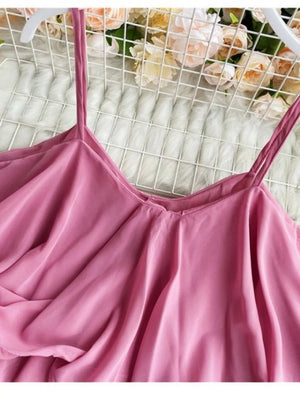 Pink camisole with spaghetti straps and delicate ruffles.