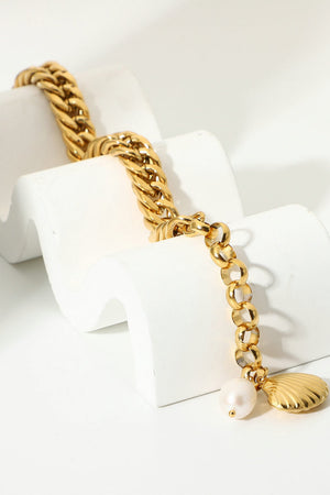Gold chain bracelet with pearl and shell charms