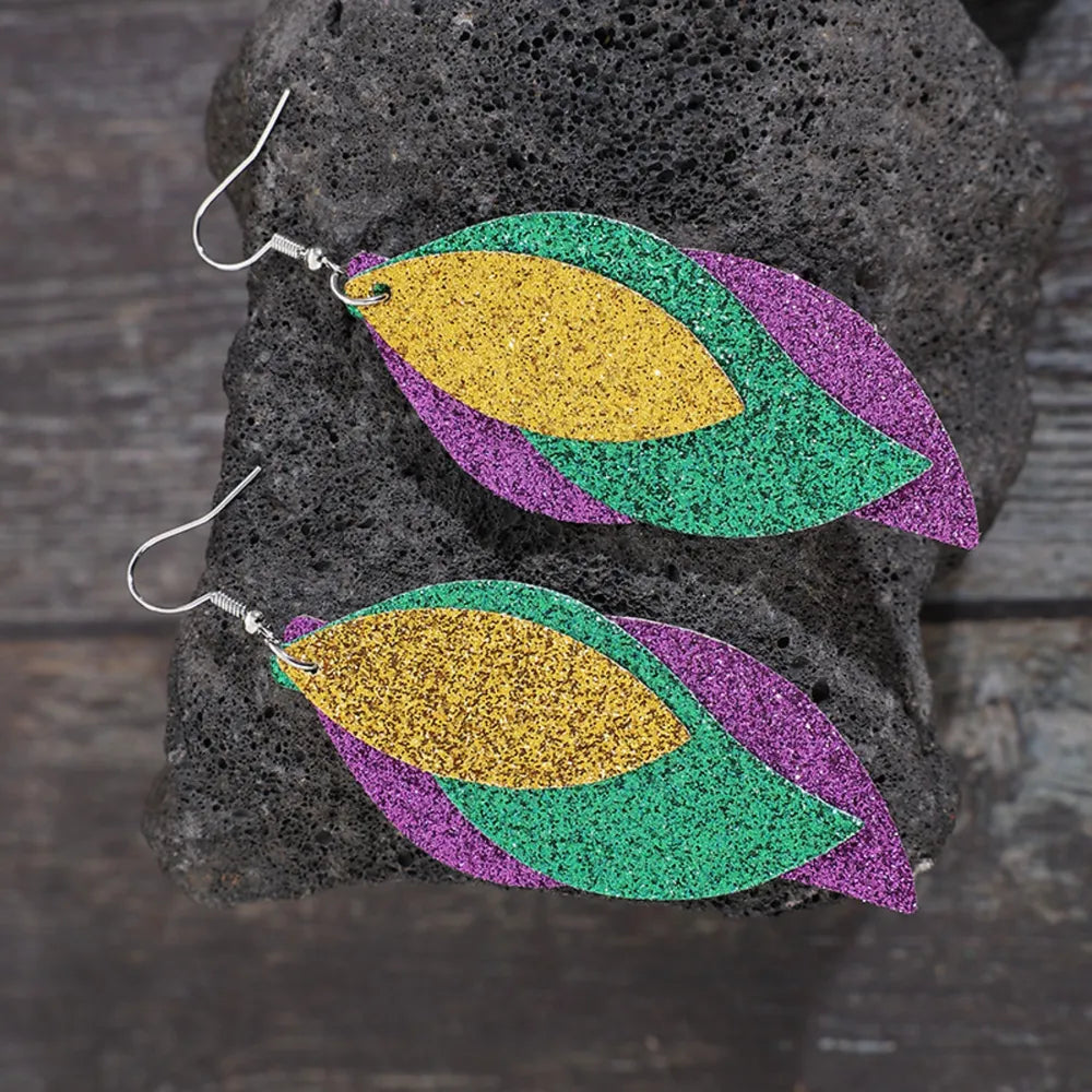 Glittering layered leaf statement earrings in green, purple, and gold.
