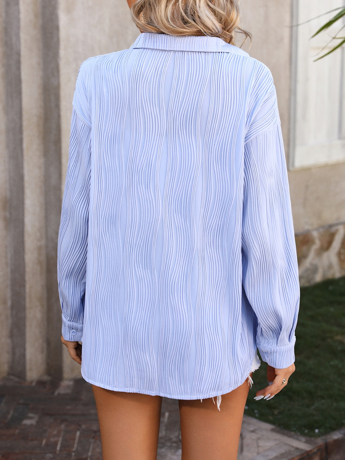 Light blue textured pleat oversized button-down shirt with long sleeves.
