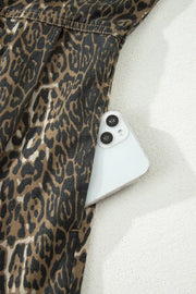 Leopard print denim dress with a pocket holding a smartphone