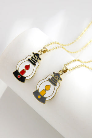 Spooky Season enamel pendant necklaces, one with red flame, one with yellow flame.