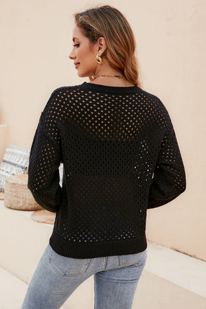 Black open-knit crewneck sweater with subtle texture, long sleeves and ribbed hem.