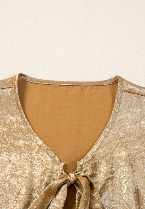 Gold Luxe Bow-Front Peplum Blouse with V-neck and tie detail.