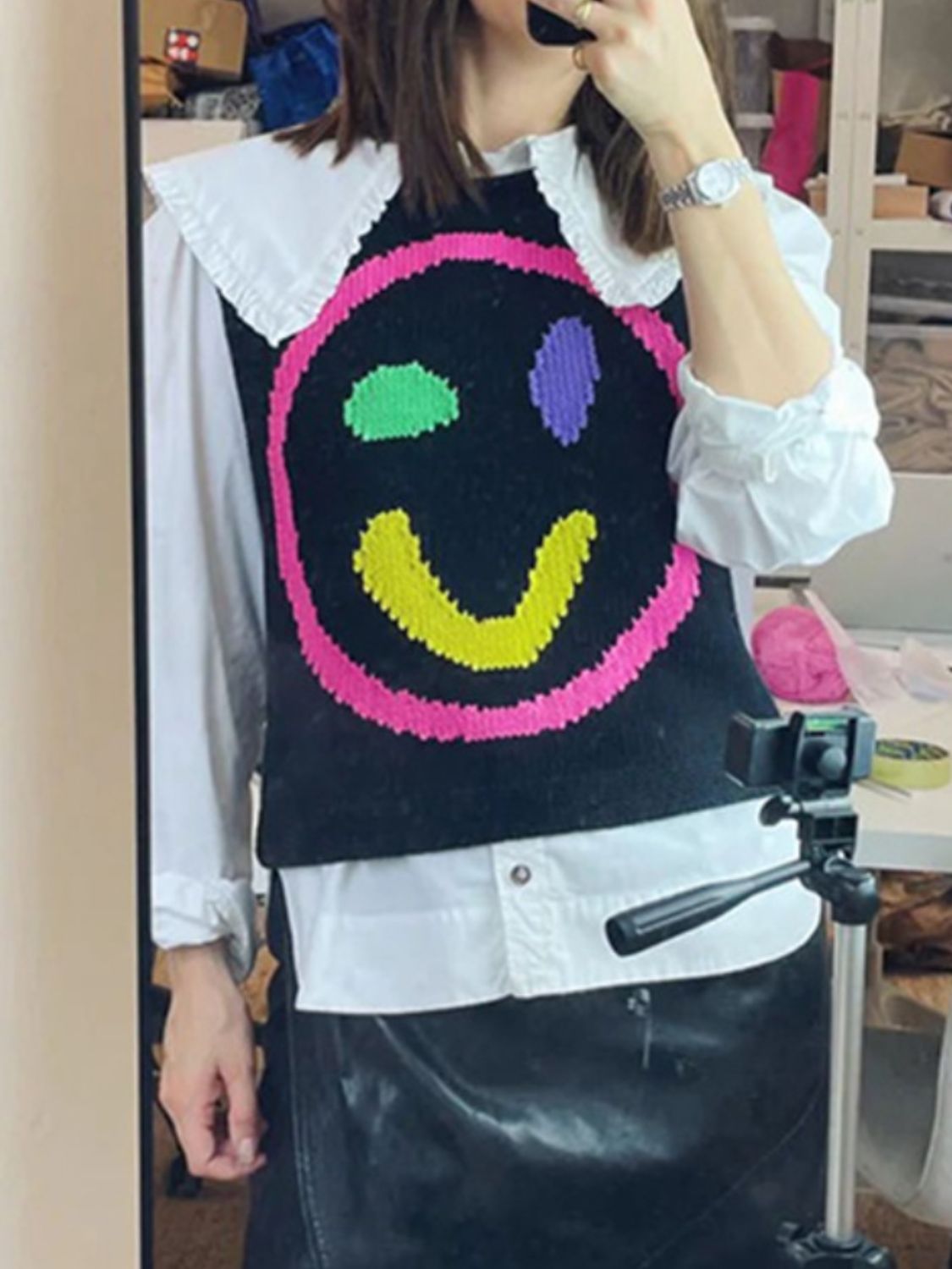 Black knit tank top with colorful smiley face and ruffle collar detail