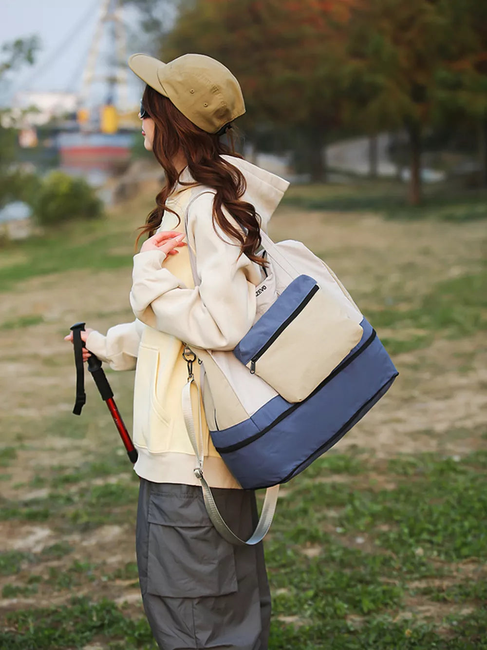Chic nylon travel bag in blue and tan with multiple carrying options.