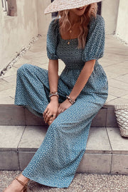 Cerulean floral print square neck jumpsuit with puff sleeves and wide legs.