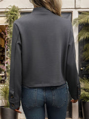 Dark gray ribbed stand-collar blazer with buttoned cuffs.