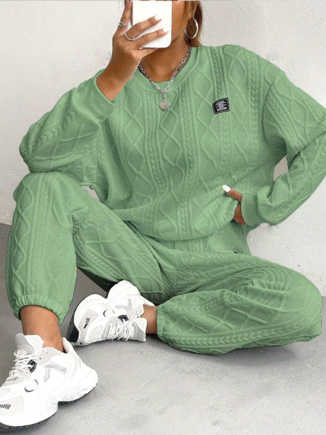 Textured cable knit loungewear set in Gum Leaf green, featuring a crewneck sweatshirt and relaxed pants.