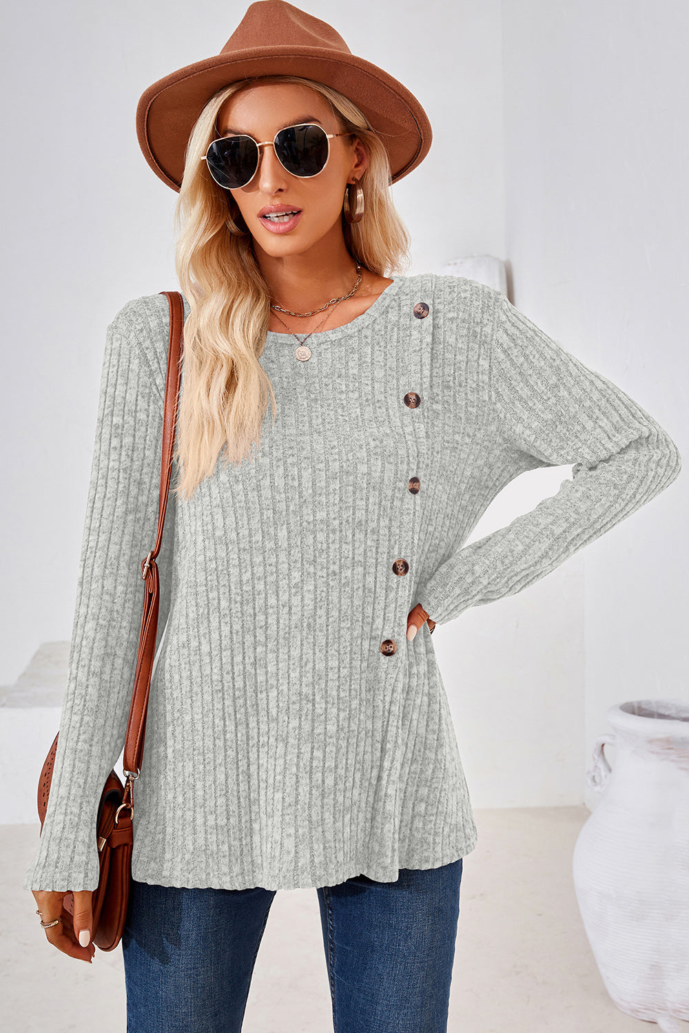 Light Gray ribbed knit sweater with asymmetric button detail and long sleeves.