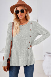 Light Gray ribbed knit sweater with asymmetric button detail and long sleeves.