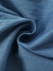 Blue denim fabric detail of a baby dress