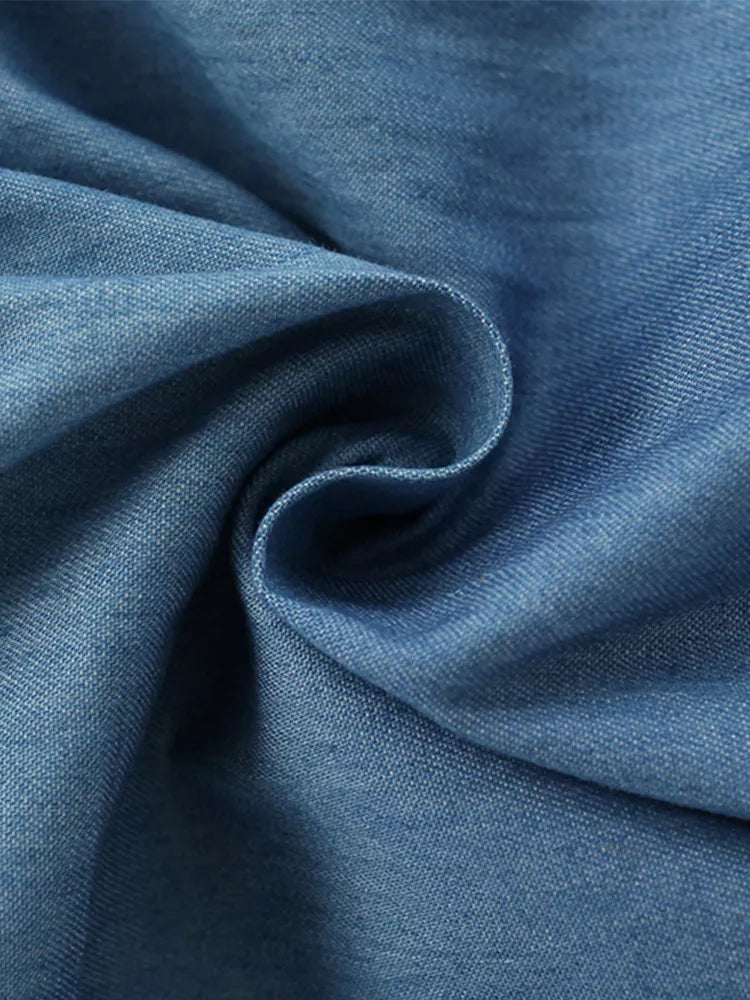 Blue denim fabric detail of a baby dress
