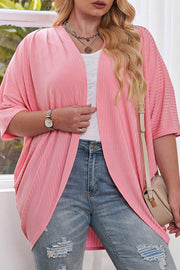 Pink ribbed batwing cardigan with drape front and wide sleeves.