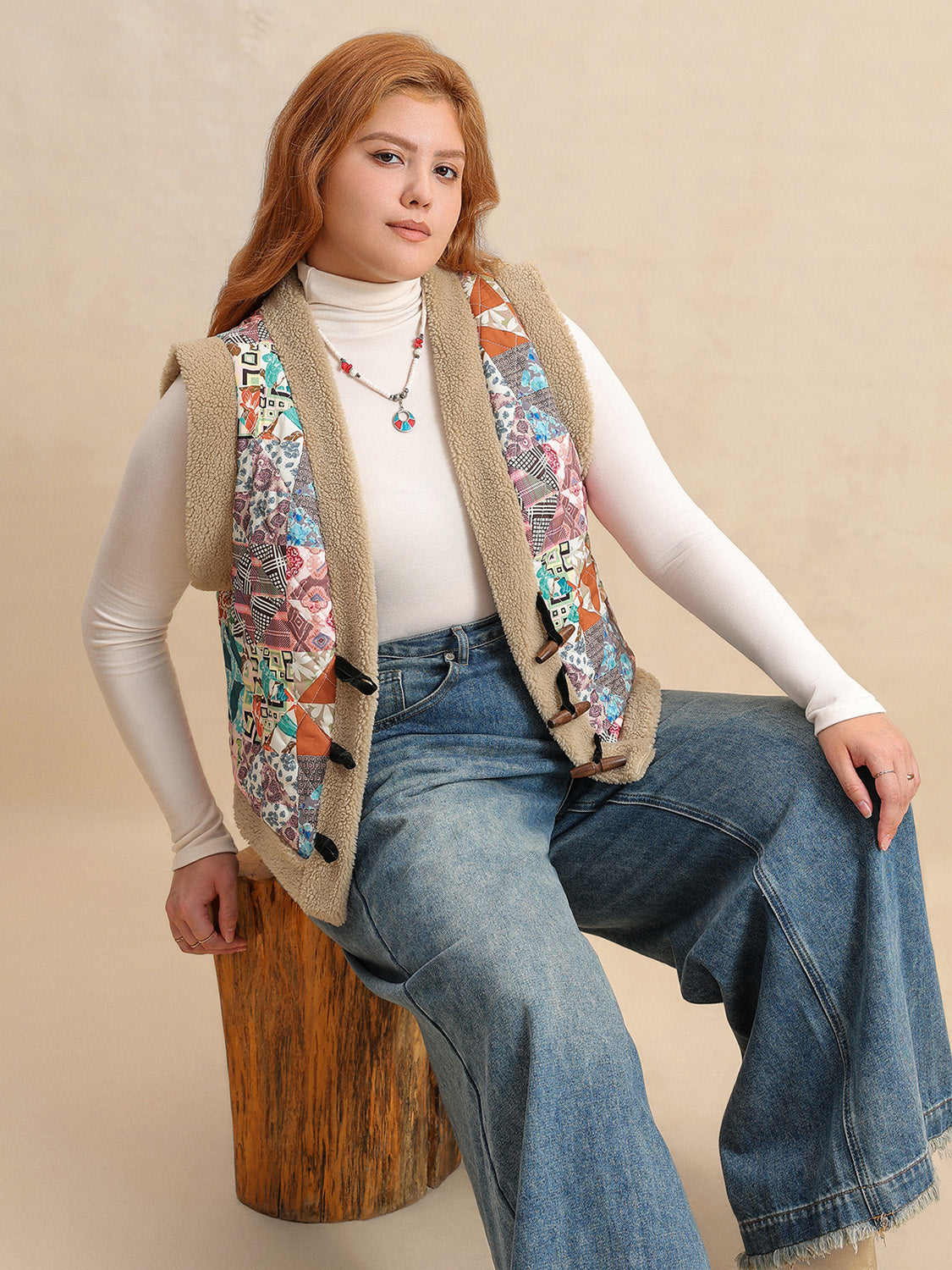 Patchwork sherpa toggle vest with multicolor boho print and tan trim.