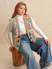 Patchwork sherpa toggle vest with multicolor boho print and tan trim.