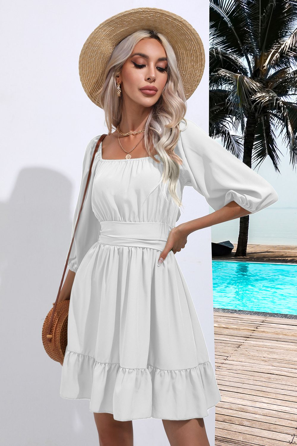 White mini dress with square neck, puff sleeves, cinched waist, and tiered ruffle hem.