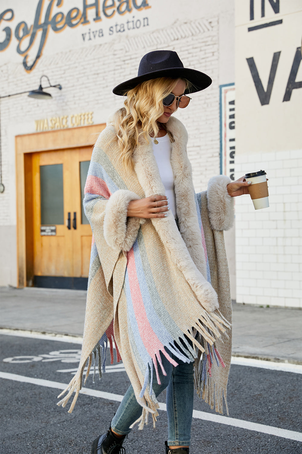 Textured stripe poncho with faux fur trim and fringe, in a neutral multi-color stripe.