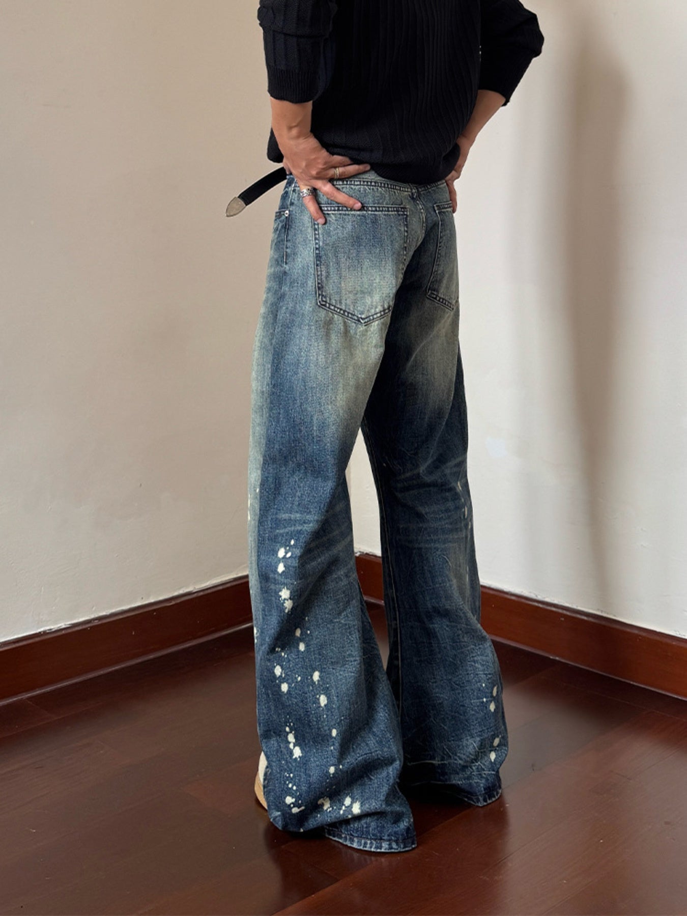Men's blue 100% cotton wide leg jeans with vintage wash and white paint splatter detail.