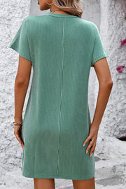 Green ribbed tee dress with vertical white stripes and short sleeves.