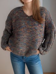 Textured knit sweater with balloon sleeves and V-neck in a multi-color speckled yarn.