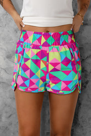 Geometric prism running shorts in multicolor with a comfortable elastic waistband and side slits.