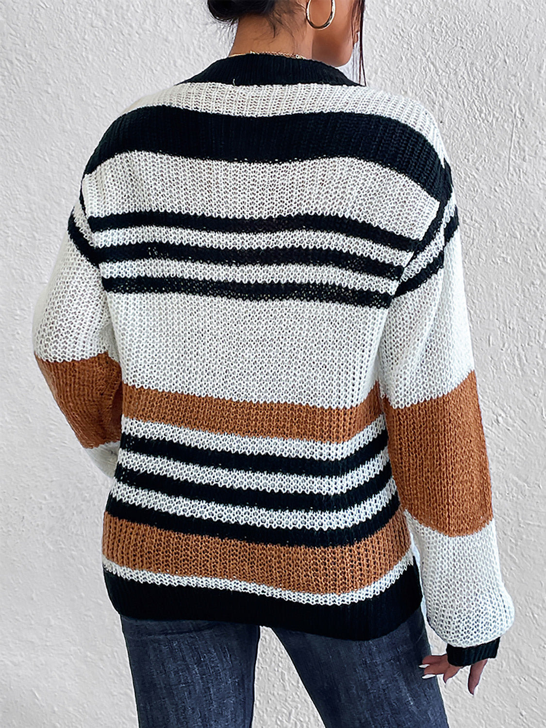 Colorblock stripe knit crewneck sweater in caramel, black, and white acrylic.