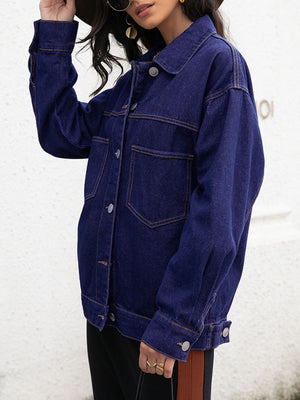 Dark oversized denim trucker jacket with contrast stitching and buttoned front.