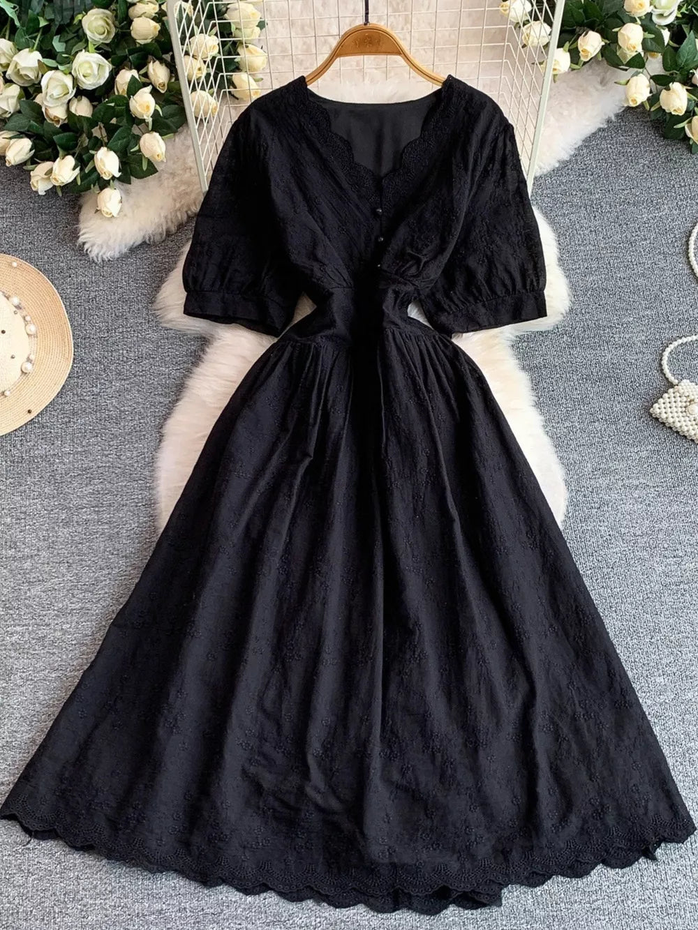 Black lace-embellished A-line midi dress with V-neck and short puff sleeves.