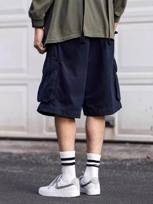 Navy blue cargo shorts with drawstring waist and multiple pockets.