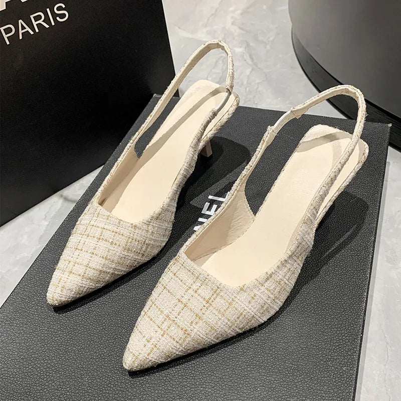 Beige tweed slingback kitten heels with pointed toe and elastic strap.