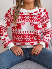 White and red jacquard knit sweater with reindeer and snowflake pattern.