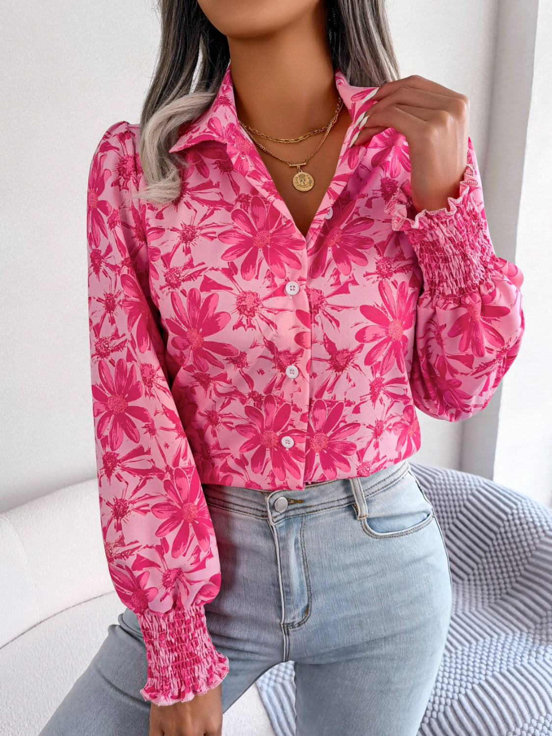 Pink floral print blouse with shirred cuffs and button front.