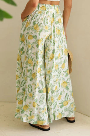 Botanical print palazzo trousers with a ruffled waistband and wide legs.