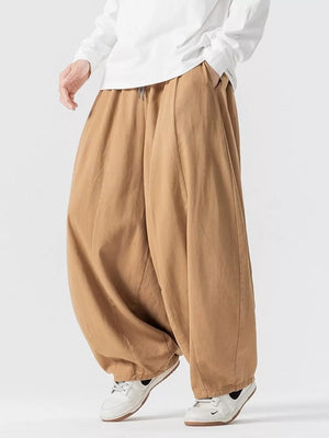 Relaxed fit drawstring sweatpants in tan with pockets and a baggy cut.