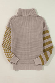 Checkerboard & stripe sleeve knit turtleneck sweater in mocha with a waffle knit body and ribbed cuffs.