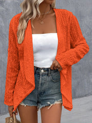 Orange open-weave cardigan with draped front and long sleeves.