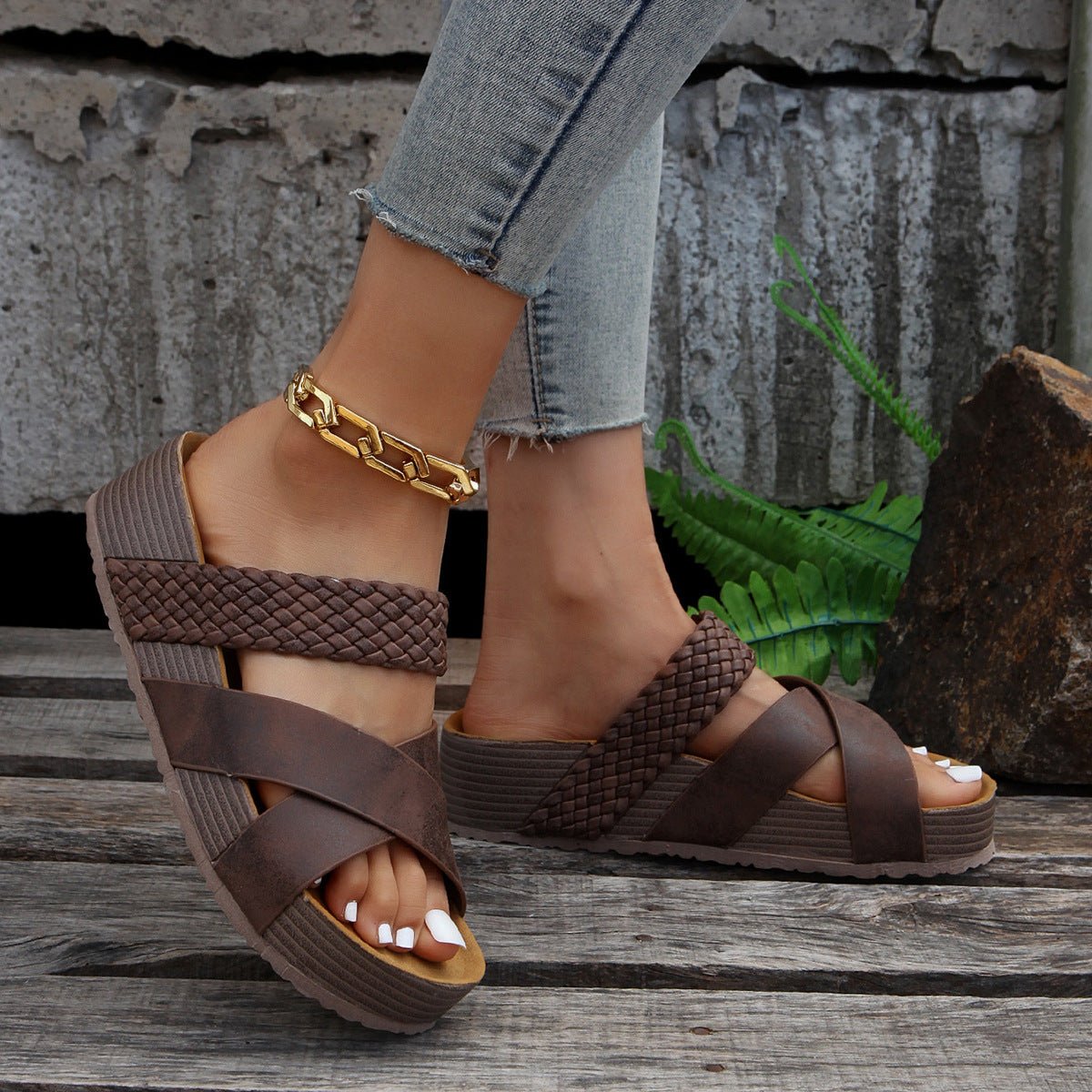 Braided strap platform sandals in coffee with crisscross straps and a thick sole.