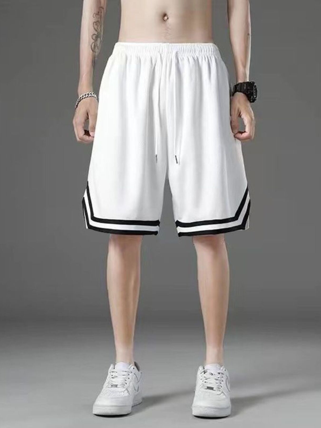 White athletic shorts with drawstring and black stripe detail on hem.