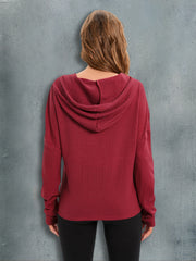 Red Orange waffle knit relaxed fit hoodie with a hood and long sleeves.
